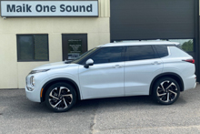 White 2024 Mitsubishi Outlander with dark privacy window tint